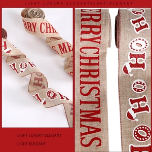 Close-up of Merry Christmas print on rustic burlap ribbon with festive red glitter letters