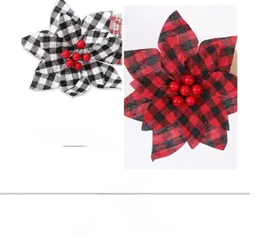 Detail of buffalo plaid Christmas flowers with red berries in rustic fabric style