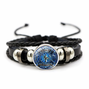 Detailed macro view of the multi-layer leather firefighter bracelet with glass cabochon charm