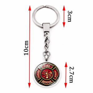 Silver metal fireman keychain with red Maltese cross emblem and firefighter motifs