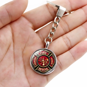 Silver firefighter keychain with glass cabochon featuring Maltese cross rescue logo