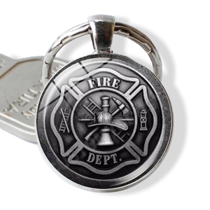 Detailed close-up of a silver Fire Dept badge keychain with a glass dome and alloy base