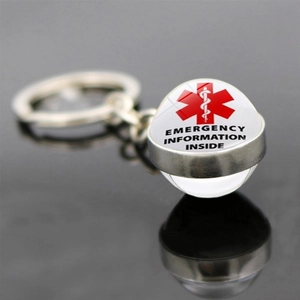 Macro view of emergency information keychain with red Star of Life symbol and metal ring