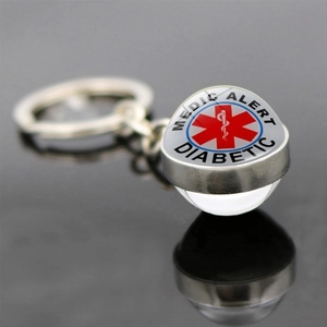 Macro detail of silver medical alert keychain with glass ball for diabetic patients