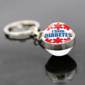 Diabetes medical alert keychain with silver metal base and glass ball showing medical warning