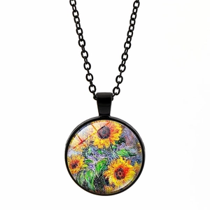 Detail of artistic sunflower pendant necklace with a black chain and glass cover