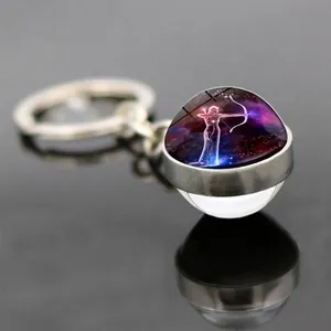 Macro shot of Sagittarius constellation glass ball keychain with silver alloy base