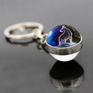 Double-sided glass ball keychain with Capricorn constellation on a silver metal ring