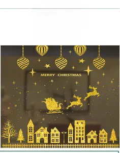 Close-up of golden glitter Christmas window stickers with Santa, reindeer and stars