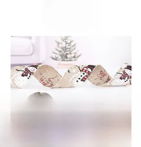 Detail of Christmas ribbon with snowman print on faux burlap fabric for festive tree decor