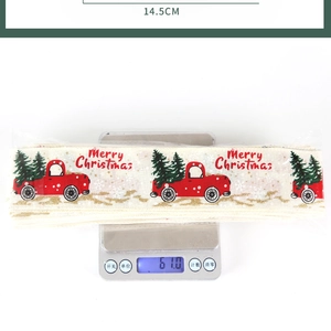 Detailed view of Christmas ribbon width 14.5cm and weight 61.0g on a digital scale