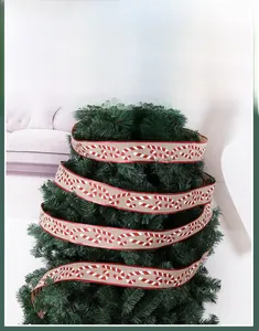 Detail of Christmas ribbon with candy cane print and red glitter edges on tree