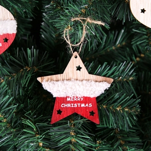 Star-shaped plush and wood Christmas ornament with Merry Christmas text on a tree