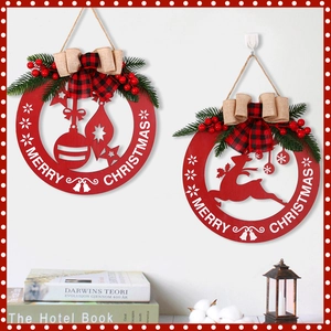 Set of two red wooden Christmas door hangers with reindeer and bauble cutout designs