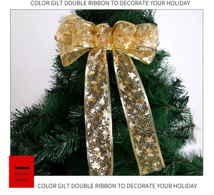 Golden double-layer ribbon bow with glitter stars and notes on a Christmas tree