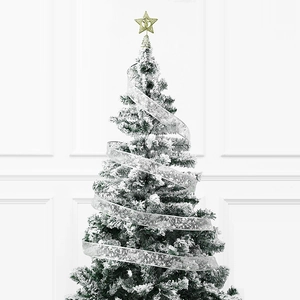 Flocked artificial Christmas tree with silver snowflake ribbon and golden star tree topper