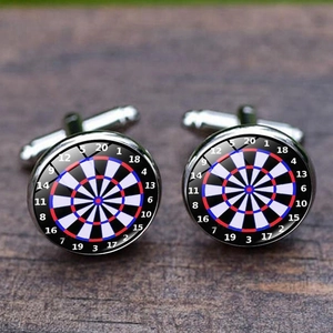 Polished silver dartboard cufflinks with crystal dome on dark wood grain background