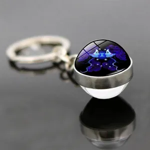 Macro detail of Gemini luminous double-sided glass ball keychain with mirror reflection