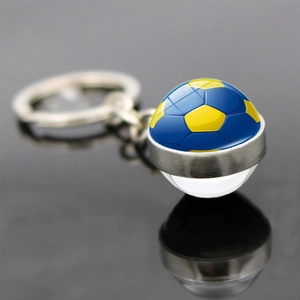 Porte-clés ballon de foot en verre double face avec motif jaune et bleu et anneau métal