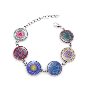 Detail of silver mandala charm bracelet with colorful geometric glass cabochons