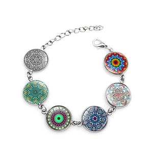 Detail of silver mandala bracelet featuring six colorful glass dome geometric patterns