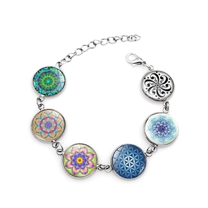Detail of silver chain bracelet with colorful mandala glass cabochons and lobster clasp