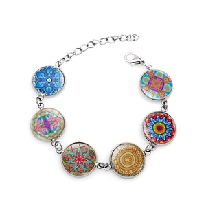 Detail of silver yoga mandala bracelet featuring six colorful glass crystal cabochons