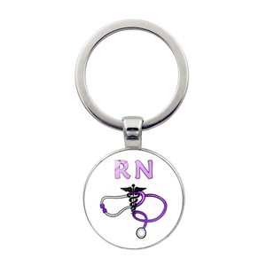 Detailed view of silver RN medical keychain with stethoscope and caduceus design
