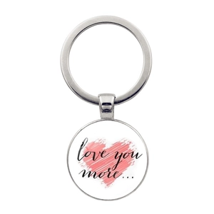 Detail showing round metal keychain with pink heart pattern and Love You More text