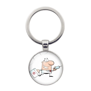 Macro detail of silver medical keychain featuring a cartoon doctor with syringe and medical kit