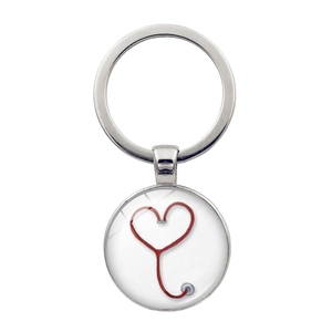Detailed view of round glass pendant keychain featuring a red heart stethoscope design