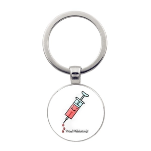 Silver metal keychain with round glass pendant featuring Proud Phlebotomist syringe design