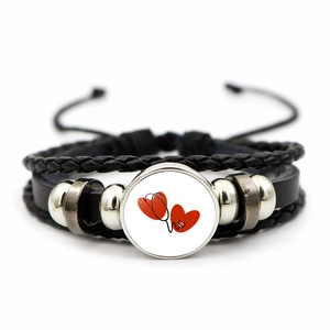 Detail of multi-layer leather braided bracelet with nurse heartbeat glass dome charm