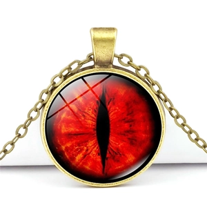 Macro view of vintage bronze dragon eye necklace pendant with red glass stone detail