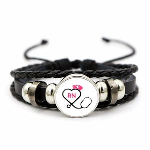 Detailed view of handmade multilayer leather bracelet with RN nurse theme glass dome charm