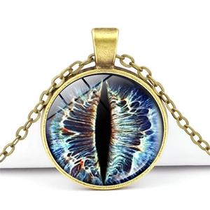 Detailed view of dragon eye glass gem pendant in antique bronze alloy setting