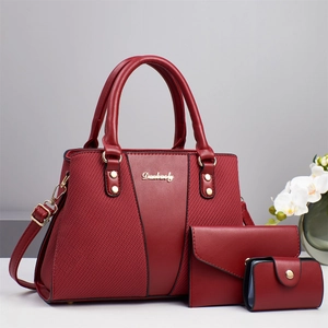 Three-piece burgundy leather handbag set with tote, wallet and pouch for daily commute