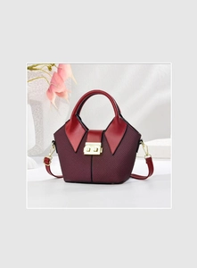 Close-up of elegant wine red bucket bag with unique collar-shaped flap and gold hardware