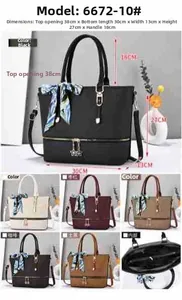 Vista dettagliata della borsa capiente con cerniera decorativa e foulard di seta sul manico