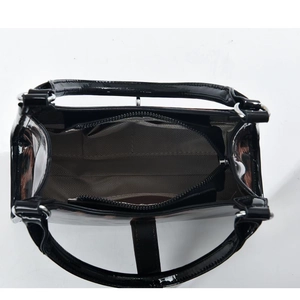 Top-down view of the black patent leather bag interior with a central zipper compartment