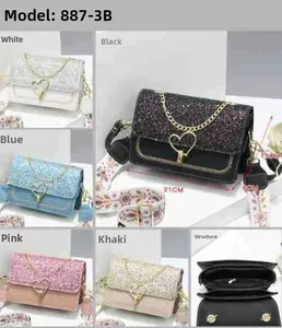 Detail of sequin crossbody bag with heart chain and ethnic style embroidered strap