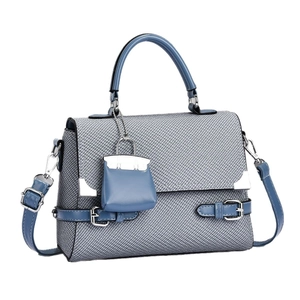Blue and grey canvas tote bag with adjustable shoulder strap and miniature charm