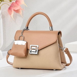 Minimalist square crossbody handbag with woven texture and a miniature charm pendant