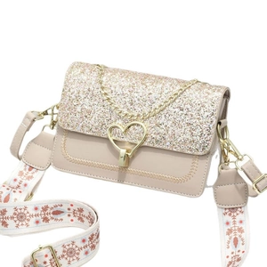 Sparkling sequin handbag with heart buckle and V-shaped stitching in champagne gold