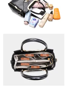 Detailed internal structure of black faux crocodile tote showing multiple compartments