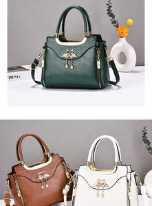 Detailed view of women's tote bag featuring a gold swan buckle and premium leather texture