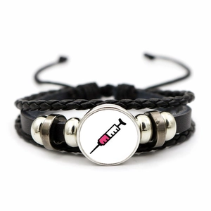 Detail of multi-layer leather bracelet featuring medical syringe glass dome and metal beads