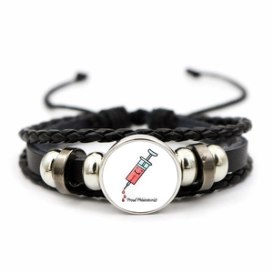 Detail of multi-layer leather bracelet with syringe motif and Proud Phlebotomist text