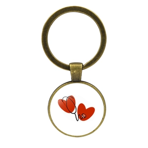Detail of bronze medical keychain showing heart and stethoscope graphic pendant