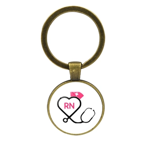 Detail of bronze medical keychain featuring an RN heart stethoscope and pink nurse hat charm